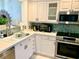 Updated kitchen with stainless steel appliances and white cabinets at 8630 Midnight Pass Rd # 103A, Sarasota, FL 34242