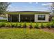 Rear view of home with covered patio and landscaped yard at 4952 Surfside Cir, Bradenton, FL 34211