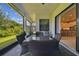 Covered patio with seating area and view into kitchen at 4952 Surfside Cir, Bradenton, FL 34211