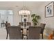 Elegant dining room with a glass-top table and modern chandelier at 4952 Surfside Cir, Bradenton, FL 34211