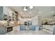 Open concept kitchen with island, dining area, and views into the living room at 4952 Surfside Cir, Bradenton, FL 34211
