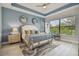 Relaxing main bedroom with light wood flooring, a ceiling fan, and large windows at 4952 Surfside Cir, Bradenton, FL 34211