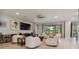 Living room with white sofas, large TV and view to backyard at 4952 Surfside Cir, Bradenton, FL 34211