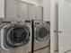 Stainless steel washer and dryer in a well-lit laundry room at 4952 Surfside Cir, Bradenton, FL 34211