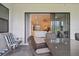 Covered patio with seating area and view into living room at 4952 Surfside Cir, Bradenton, FL 34211