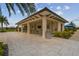 Covered outdoor seating area with tables and a TV at 4952 Surfside Cir, Bradenton, FL 34211