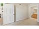 Simple bedroom with carpet, showing access to bathroom at 1050 Villagio Cir # 206, Sarasota, FL 34237