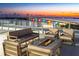 Relax with comfortable seating and a fire pit on this scenic rooftop deck at 111 Golden Gate Pt # 201, Sarasota, FL 34236