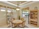 Bright breakfast nook with a round table and built-in shelving at 1130 Cielo Ct, North Venice, FL 34275