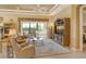 Living room with built-in entertainment center, comfortable seating and access to a bedroom at 1130 Cielo Ct, North Venice, FL 34275