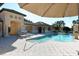 Enjoy resort-style pool with lounge chairs and covered patio at 1130 Cielo Ct, North Venice, FL 34275