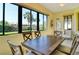 Sunroom with a wooden table, chairs and view of the backyard at 1130 Cielo Ct, North Venice, FL 34275