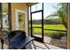 Relaxing screened patio with built-in grill and view of backyard at 1130 Cielo Ct, North Venice, FL 34275