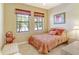 Charming bedroom with a full-size bed and window at 1130 Cielo Ct, North Venice, FL 34275