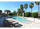 Relaxing community pool with lounge chairs and lush landscaping at 1130 Cielo Ct, North Venice, FL 34275