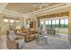 Bright living room with sliding doors leading to a sunroom and comfortable seating at 1130 Cielo Ct, North Venice, FL 34275