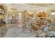 Open concept living room with adjacent kitchen and dining areas, featuring comfortable seating and large windows at 1130 Cielo Ct, North Venice, FL 34275
