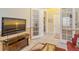 Living room with hardwood floors and French doors leading to other rooms at 1130 Cielo Ct, North Venice, FL 34275