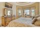 Bright bedroom with king-size bed and large windows at 1130 Cielo Ct, North Venice, FL 34275