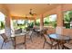 Enjoy covered seating with tables and chairs near the pool at 1130 Cielo Ct, North Venice, FL 34275
