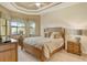 Spacious bedroom with king-size bed and wood furniture at 1130 Cielo Ct, North Venice, FL 34275