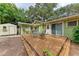 Inviting back deck for outdoor dining and relaxation, surrounded by lush greenery at 1533 1St Ave W Dr, Bradenton, FL 34205