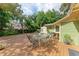 Spacious backyard featuring a dining area on a wooden deck with a shed at 1533 1St Ave W Dr, Bradenton, FL 34205