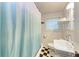 Charming bathroom features a classic black and white checkered floor and beadboard paneling at 1533 1St Ave W Dr, Bradenton, FL 34205