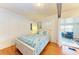 Comfortable bedroom with hardwood floors, a cozy bed, and convenient access to living area at 1533 1St Ave W Dr, Bradenton, FL 34205