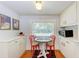 Cozy breakfast nook featuring a round table, red chairs, and a bright window at 1533 1St Ave W Dr, Bradenton, FL 34205