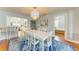Bright dining room with a modern light fixture, stylish furniture, and access to the kitchen and bedroom at 1533 1St Ave W Dr, Bradenton, FL 34205