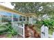 Inviting entrance with a white picket fence, lush foliage, and a quaint pathway to the front door at 1533 1St Ave W Dr, Bradenton, FL 34205