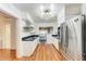 Modern kitchen with stainless steel appliances, ample cabinet space, and view of the dining room at 1533 1St Ave W Dr, Bradenton, FL 34205