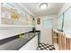 Functional kitchen with black countertops, a double sink, and ample shelving at 1533 1St Ave W Dr, Bradenton, FL 34205