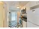 Efficient kitchen with black and white checkered floors and modern appliances at 1533 1St Ave W Dr, Bradenton, FL 34205