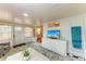 Inviting living room featuring a decorative ladder, TV, and an open entryway at 1533 1St Ave W Dr, Bradenton, FL 34205