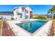 A lovely pool and spa with a two-story home in the background and a deck that connects to the upstairs at 3125 57Th Avenue E Cir, Bradenton, FL 34203