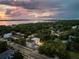 Aerial view of a modern home, showcasing the surrounding neighborhood, landscaping, and water views at 3464 Camino Real, Sarasota, FL 34239