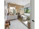 Spa-like bathroom showcasing a soaking tub, modern vanity, and natural wood accents at 3464 Camino Real, Sarasota, FL 34239