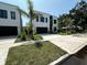 Modern two-story home featuring a clean white facade, black trim, and a well-manicured front yard at 3464 Camino Real, Sarasota, FL 34239