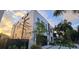 Exterior view of a modern two-story home with well-manicured landscaping and driveway at 3464 Camino Real, Sarasota, FL 34239