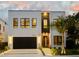 Exterior of modern two-story home featuring clean lines, dark accents, and professional landscaping at 3464 Camino Real, Sarasota, FL 34239