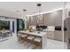 Contemporary kitchen featuring a central island, pendant lighting, and high-end stainless steel appliances at 3464 Camino Real, Sarasota, FL 34239