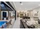 Open-concept living space with modern furnishings, a dining area, and a seamless transition to outdoor pool at 3464 Camino Real, Sarasota, FL 34239