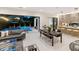 Contemporary living area that opens to an outdoor pool and includes a dining area and modern kitchen at 3464 Camino Real, Sarasota, FL 34239
