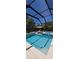 Inviting screened-in pool featuring clear blue water, lounging area, and lush landscaping at 3464 Camino Real, Sarasota, FL 34239