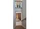 Stylish staircase with glass railing overlooking a modern console table and accent lighting at 3464 Camino Real, Sarasota, FL 34239