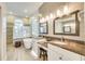 Bright bathroom featuring dual sinks, a soaking tub, and updated vanities at 4532 Shark Dr, Bradenton, FL 34208