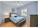 Cozy bedroom with hardwood floors, a ceiling fan, and a window with plantation shutters at 4532 Shark Dr, Bradenton, FL 34208