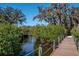 Wooden boardwalk through lush mangroves and trees at The Inlets community at 4532 Shark Dr, Bradenton, FL 34208